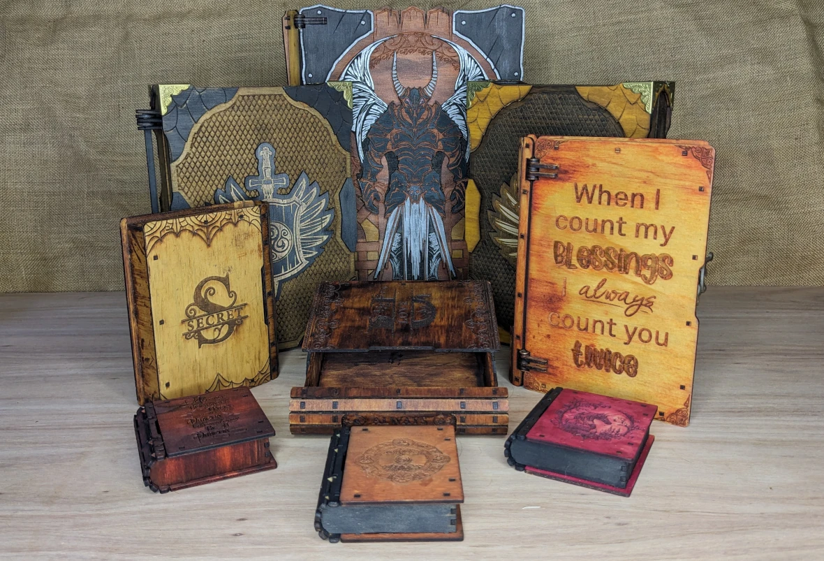 Wooden book-style storage boxes disguised as fantasy books, designed for hiding dice, trinkets, and tabletop gaming treasures.